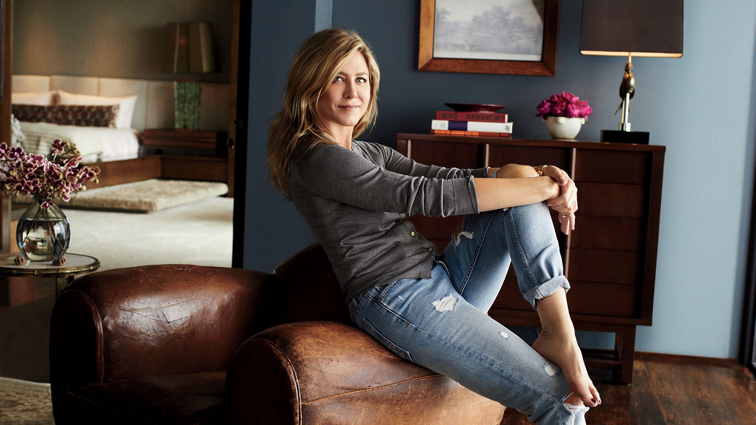jennifer aniston sitting on a chair in the living room