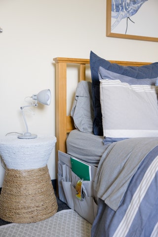 Whether youre tight on bedside table space or you dont have a table at all attaching a bedside storage caddy is a...