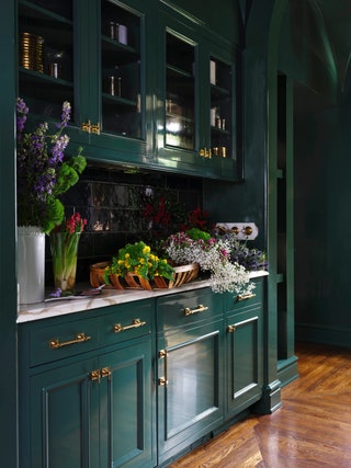 The pantrys existing cabinetry was lacquered and repainted in Benjamin Moores Lafayette Green. Hardware by Matthew Quinn...